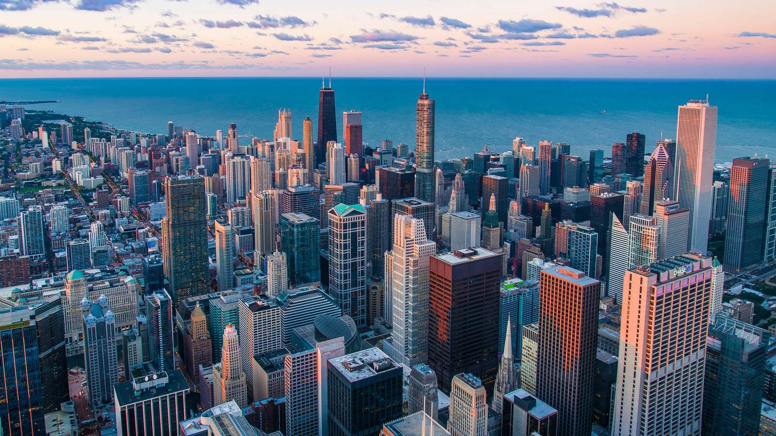 Aerial view of the Chicago skyline at sunset, looking east over Lake Michigan